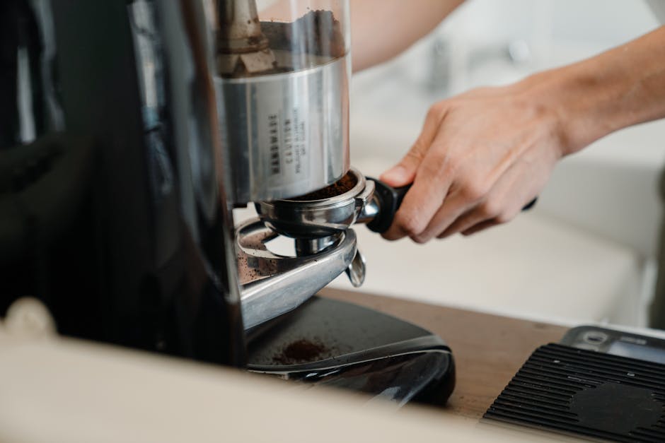 Crop person preparing coffee with machine