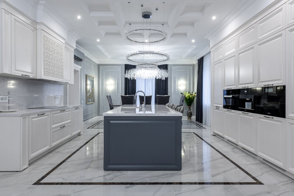 Interior of contemporary spacious kitchen with light expensive furniture placed in apartment with minimalistic design