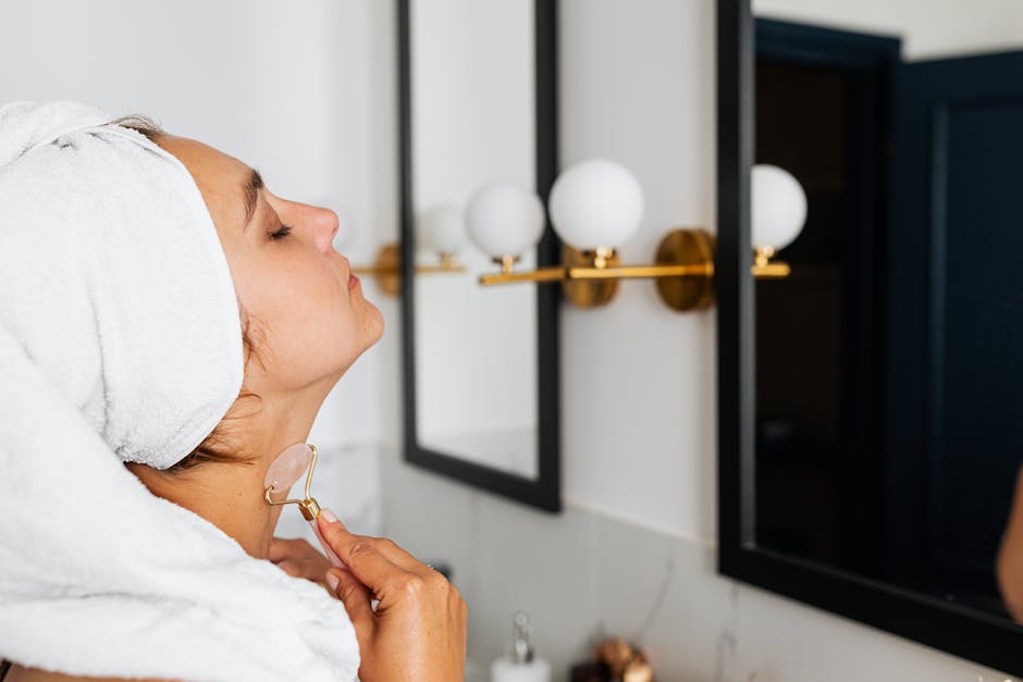 Woman With Head Towel Using a Face Roller