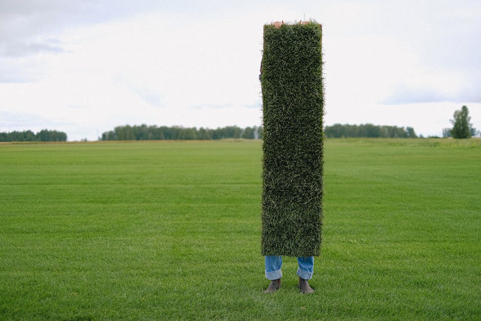 Unrecognizable farmer with grass lawn