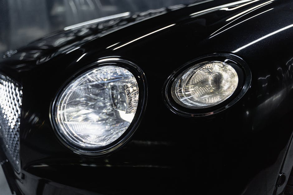 Front Headlight of a Black Car