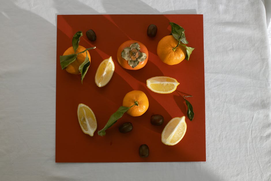 Composition of persimmons lemons and mandarins on table