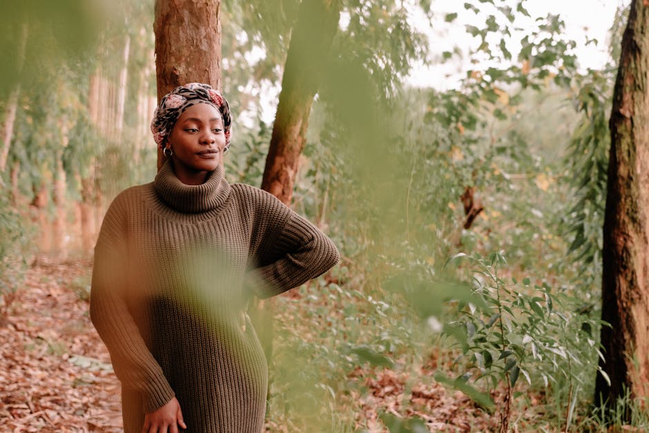 Thoughtful black woman in lush forest