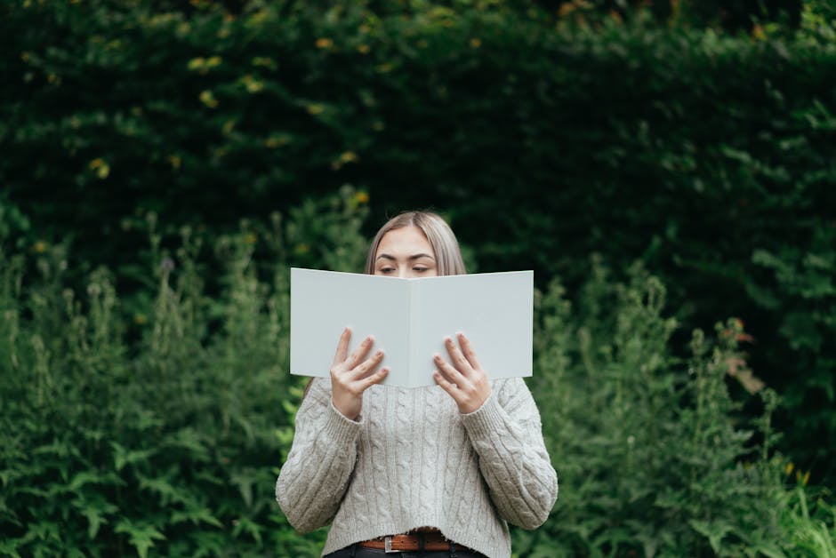 Woman reading book in green countryside