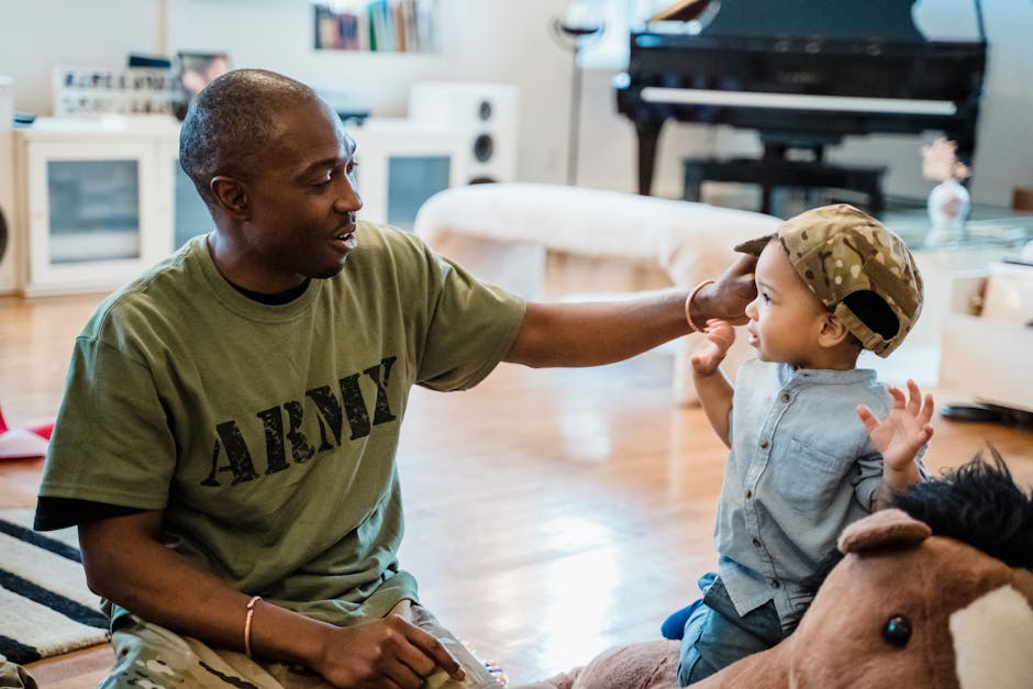 Man in Military T-Shirt Putting his Cap on His Little Son