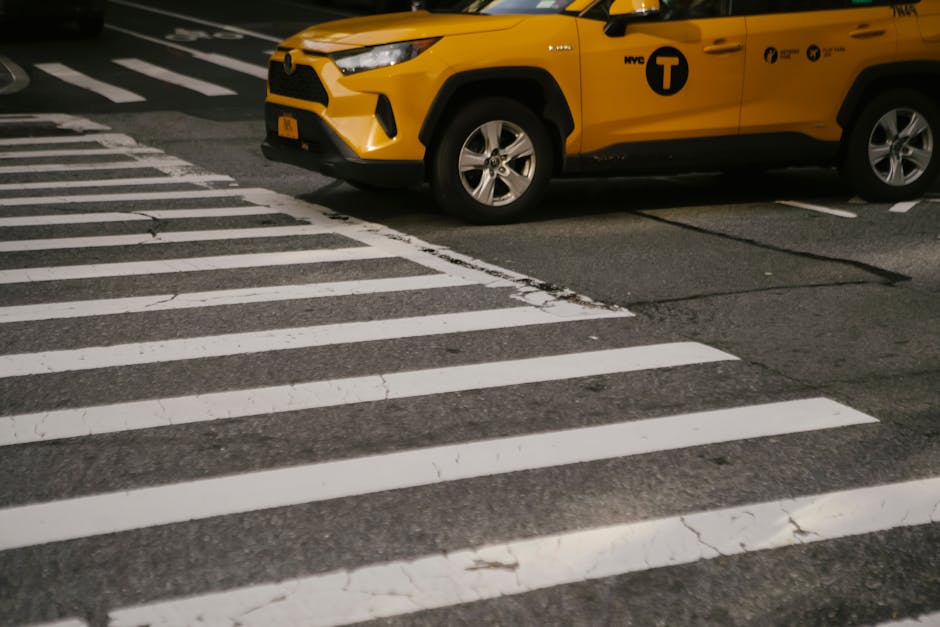 Luxury yellow crossover taxi car on zebra crossing