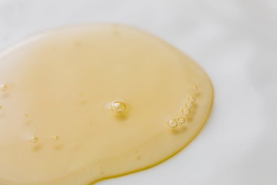 Transparent yellowish liquid on white guayabera