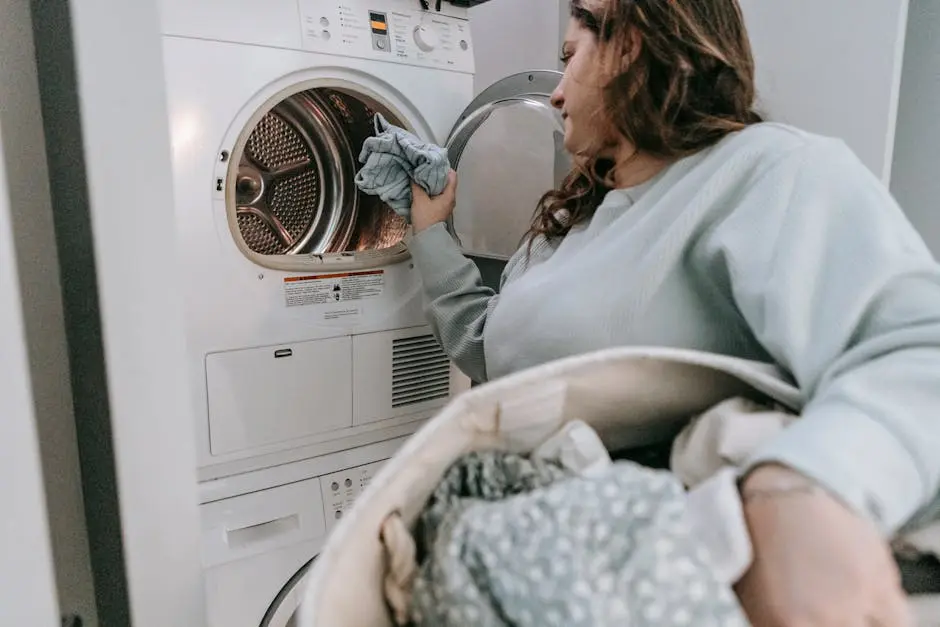 Woman loading clothes in washing machine