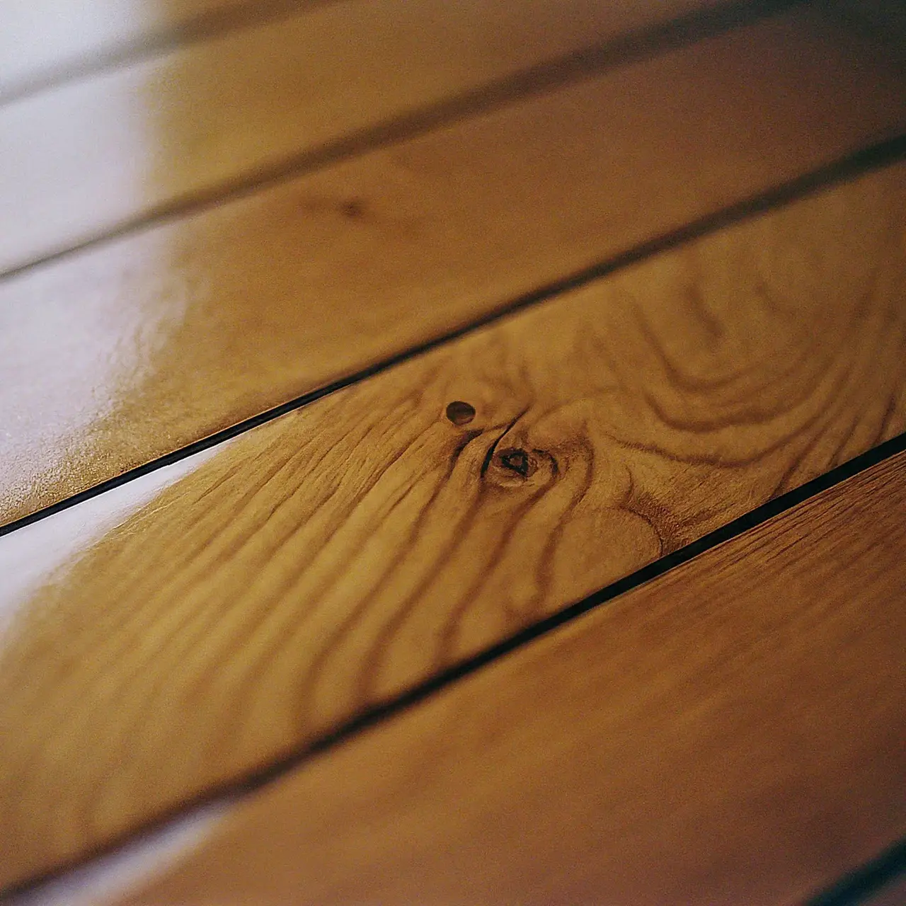 A close-up of polished wooden surface with Odie’s Oil. 35mm stock photo