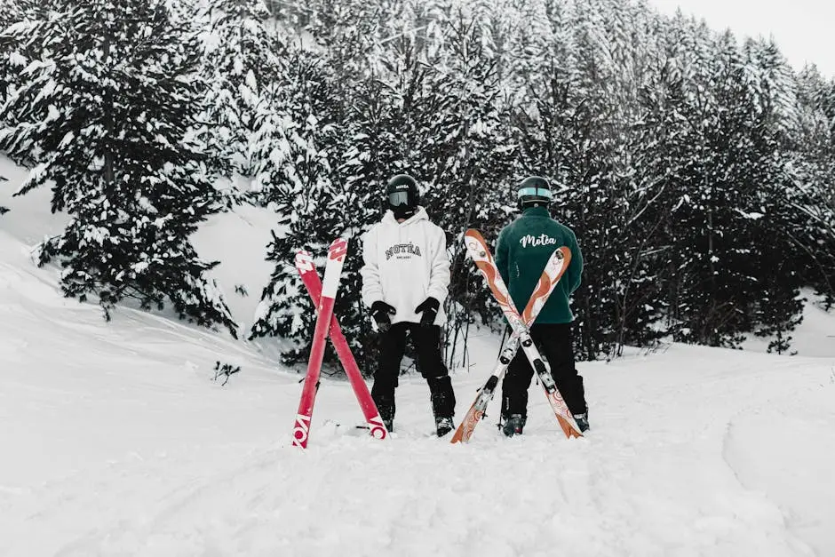 Two Skiers Wearing Goggles Standing Outdoors with their Skis