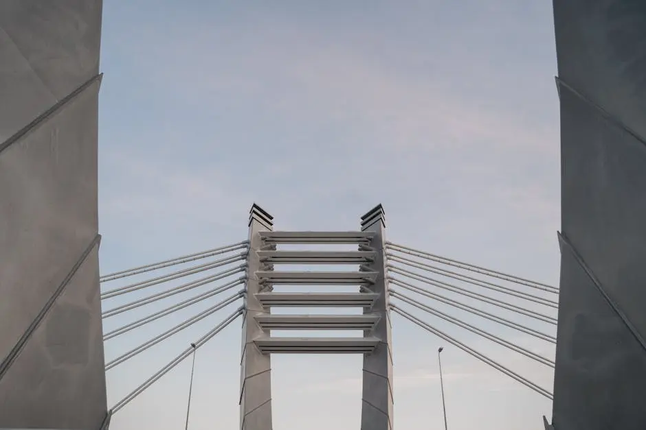 Perspective view of a contemporary cable-stayed bridge with clear blue sky backdrop.