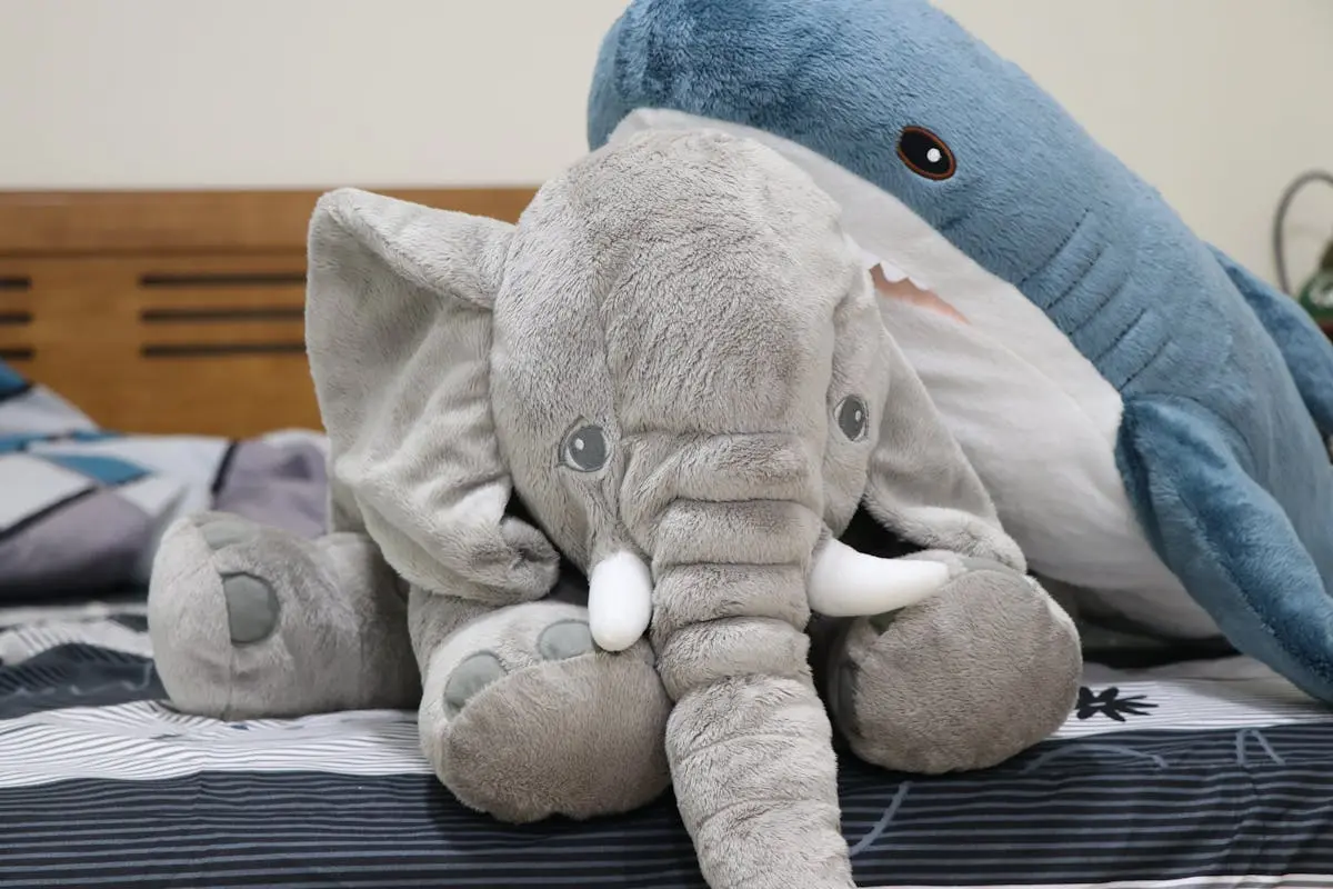 elephant and shark Animal Plush Toys on the Bed