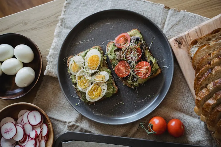 Delicious avocado toast topped with eggs and vegetables, perfect for a healthy breakfast.