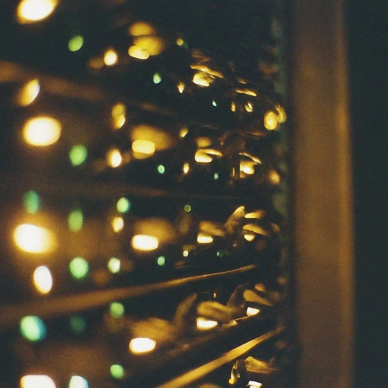 A network server rack with glowing lights in a dark room. 35mm stock photo