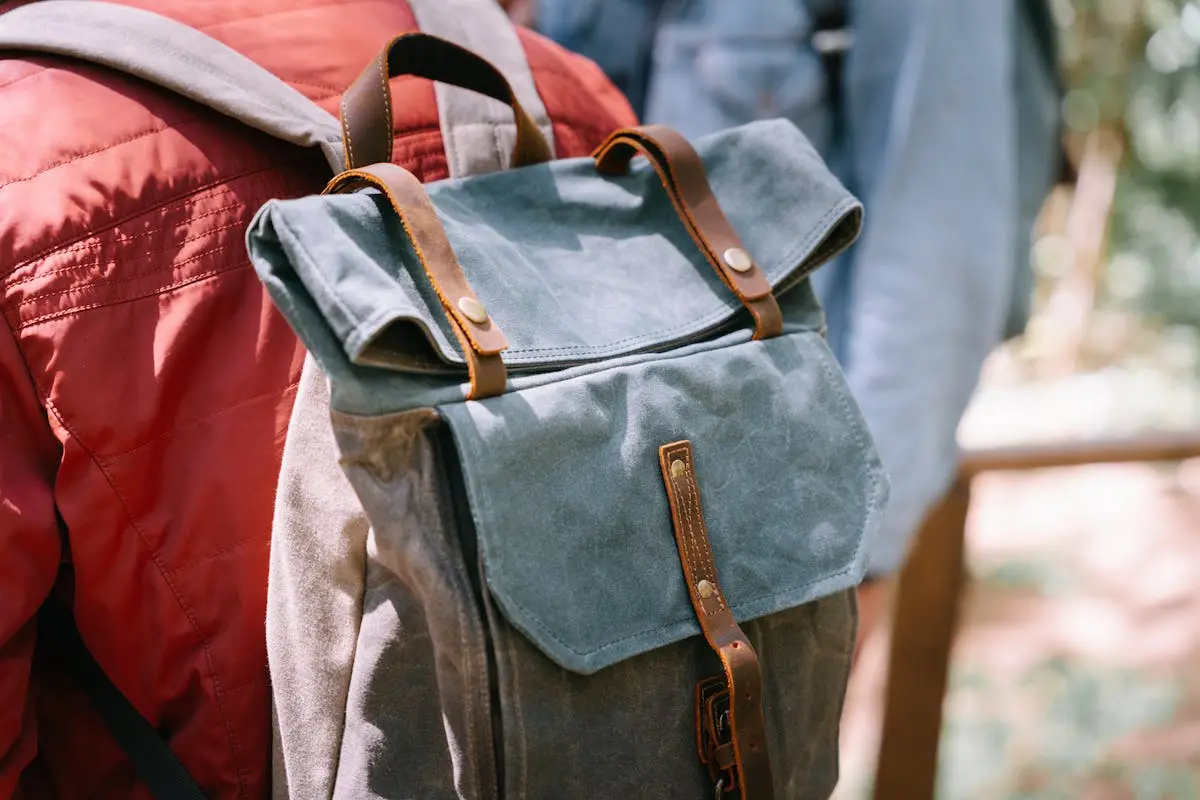 A stylish canvas backpack worn outdoors. Perfect for travel and adventure. Very durable