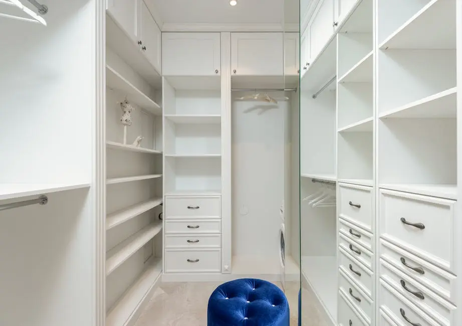 Elegant white walk-in closet with ample storage and modern design