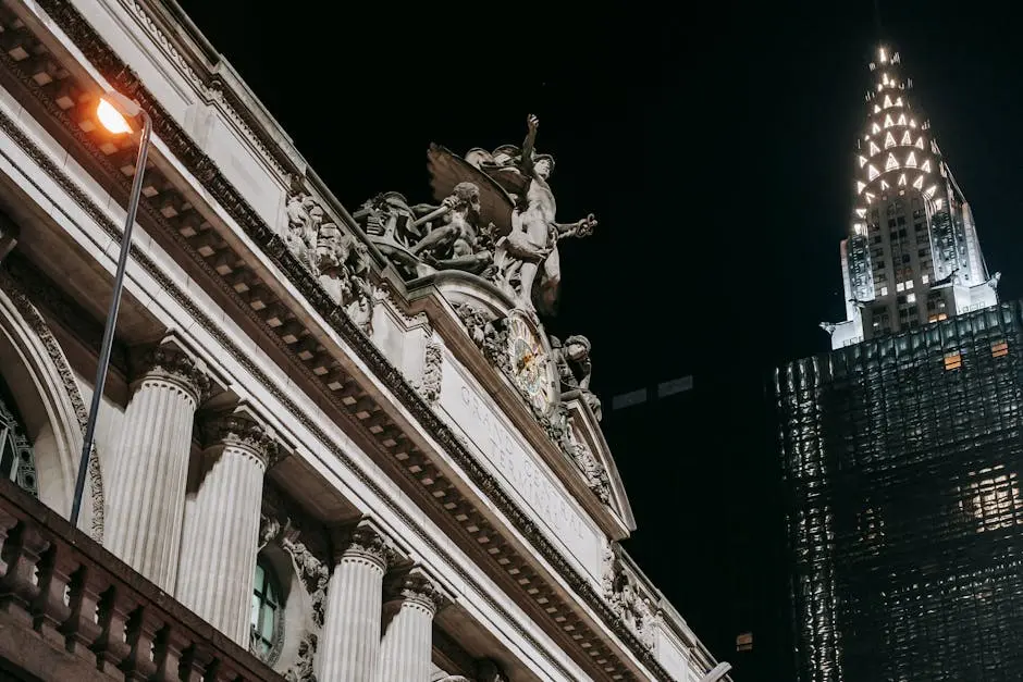 Historic stone building near modern glass tower at night