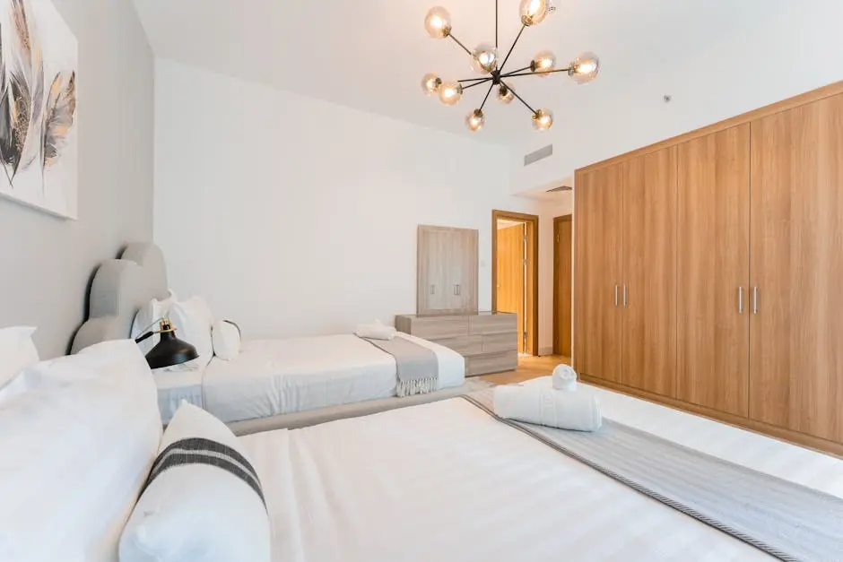 Elegant bedroom featuring minimalist design, modern lighting, and wooden furnishings.