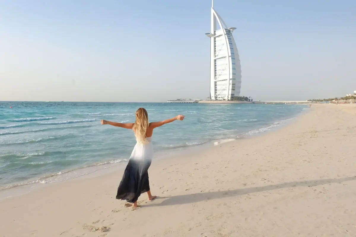 Photography of Woman Walking On Seashore