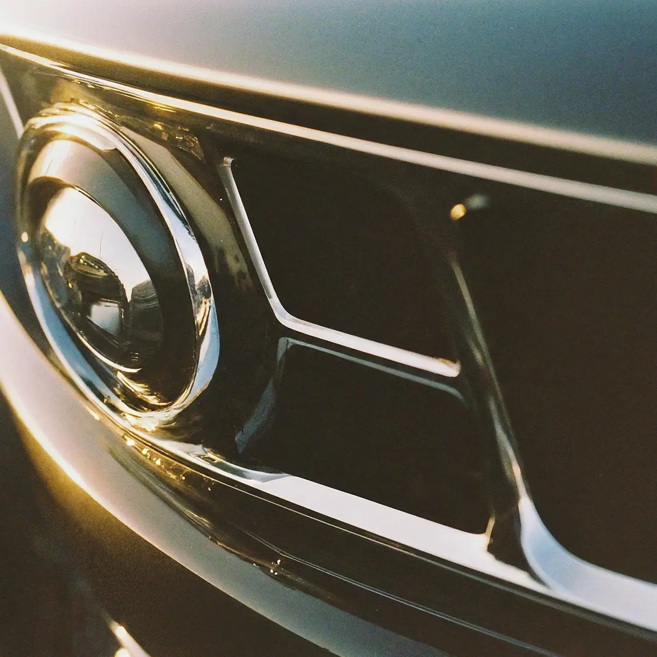 A shiny, detailed car gleaming under a bright sun. 35mm stock photo