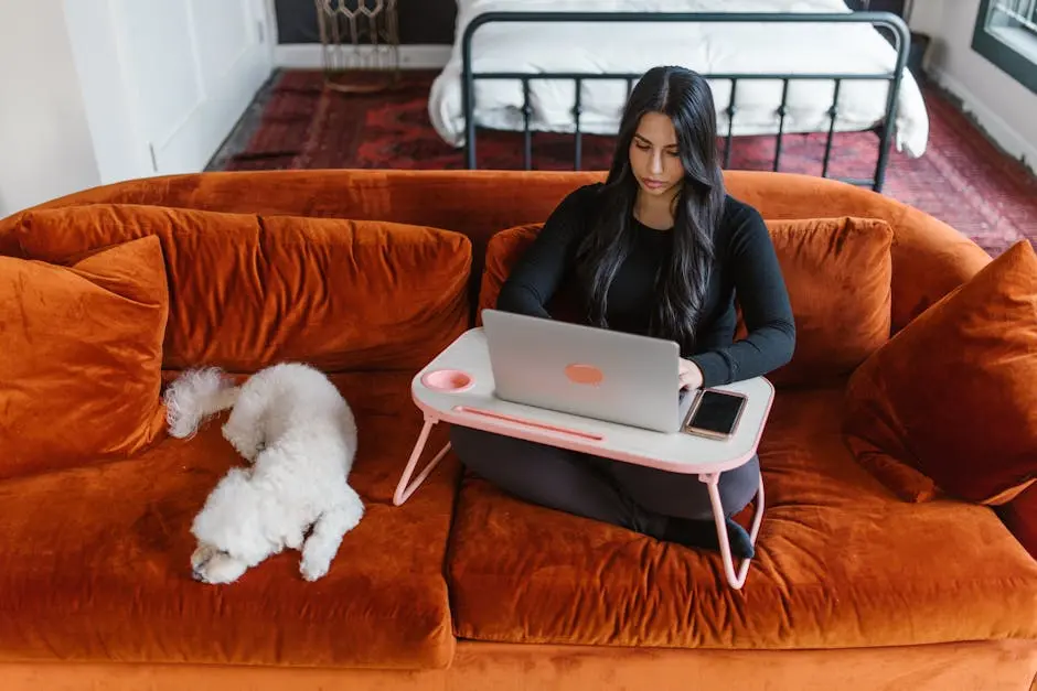 Woman Using her Laptop While Sitting Beside her Dog