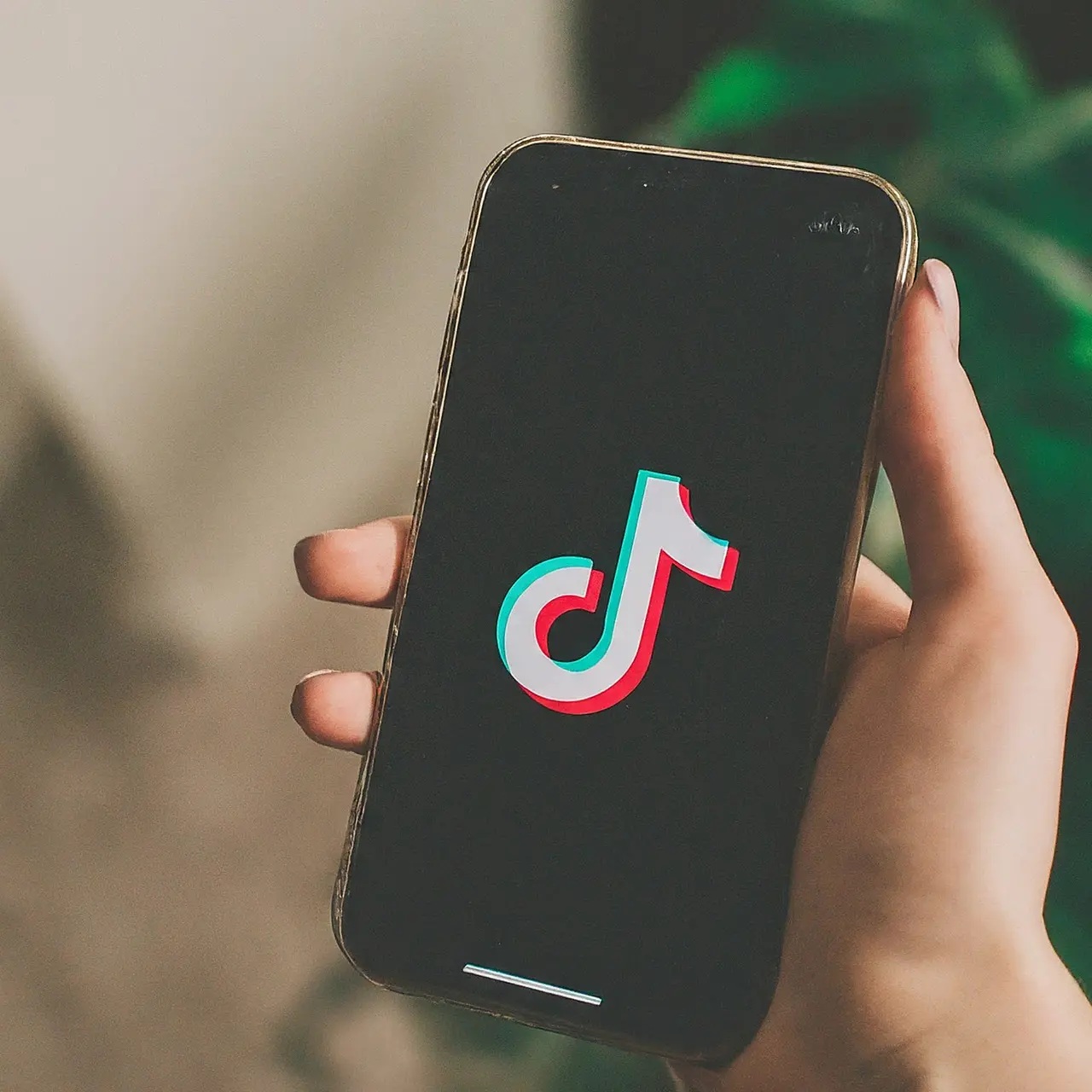 TikTok app icon on a smartphone screen with engagement icons. 35mm stock photo