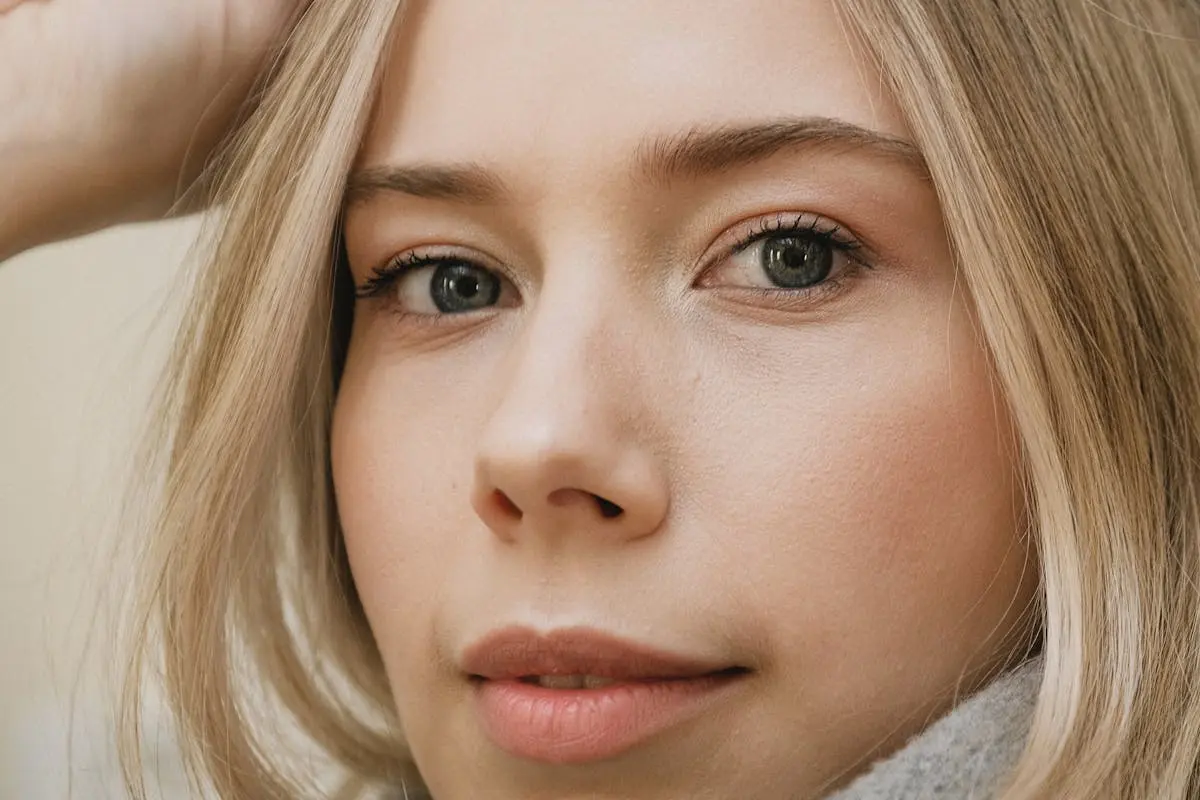 Intimate close-up of a woman’s face highlighting natural beauty and expressive eyes.