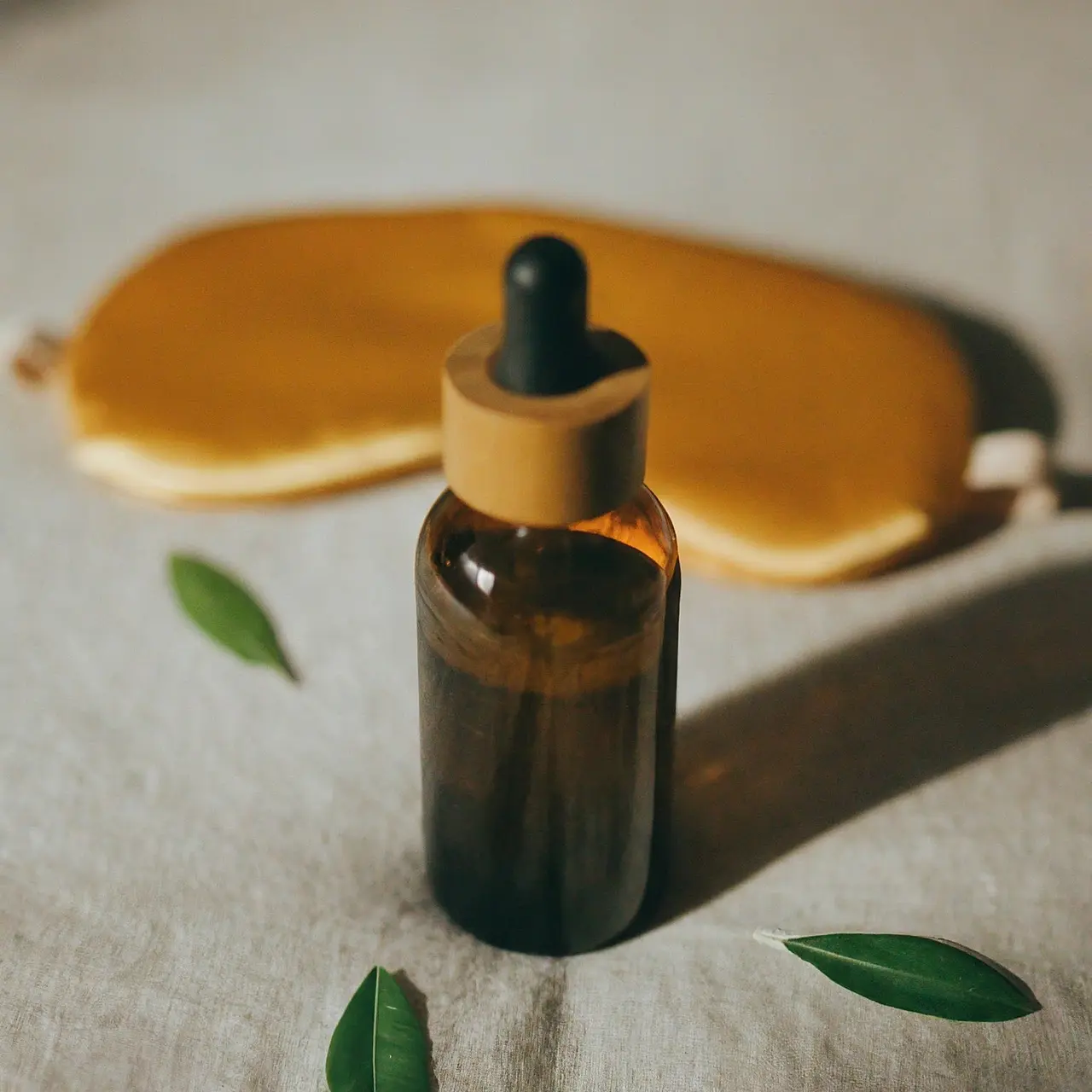 A bottle of olive leaf extract beside a sleeping mask. 35mm stock photo