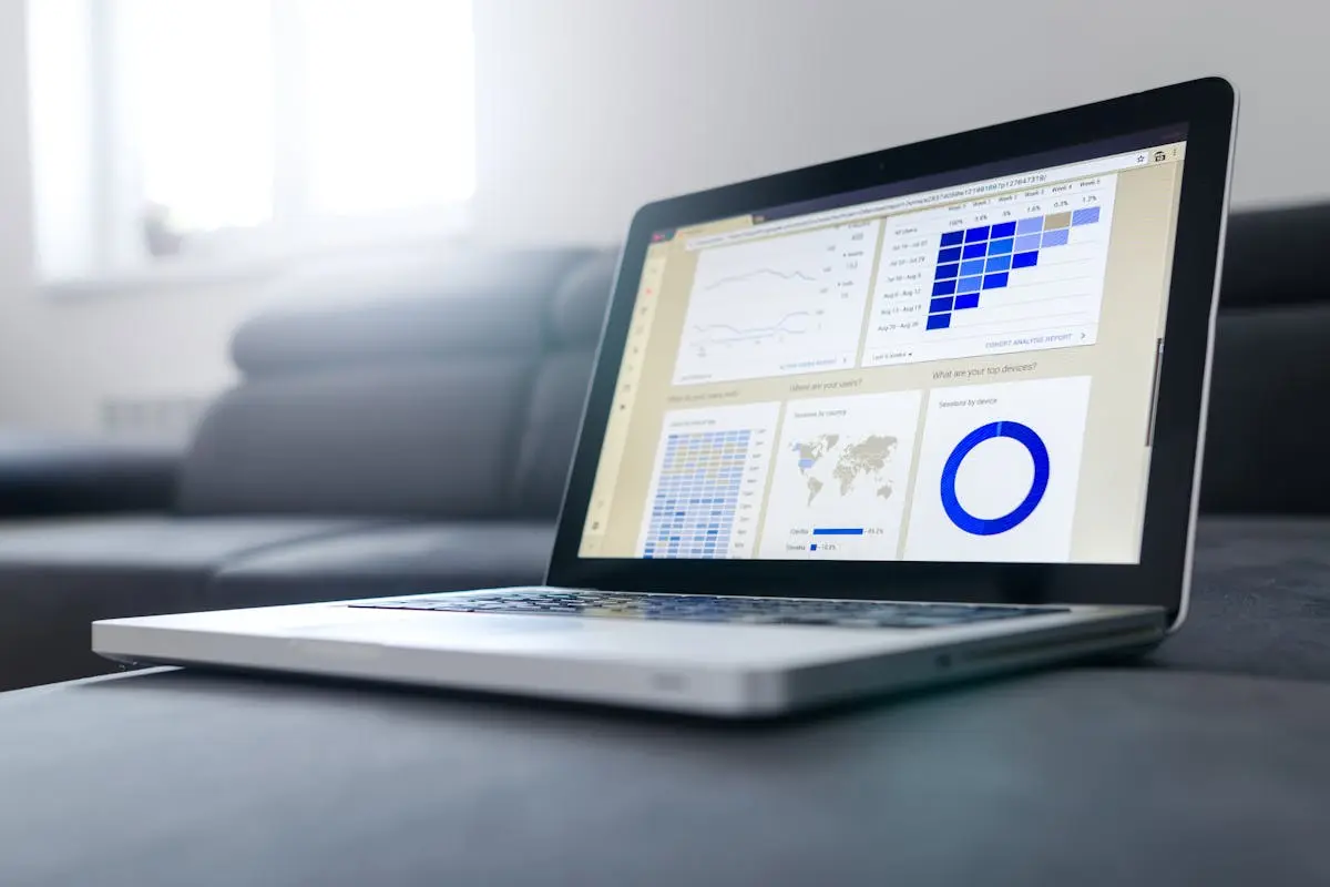 Sleek laptop showcasing data analytics and graphs on the screen in a bright room.