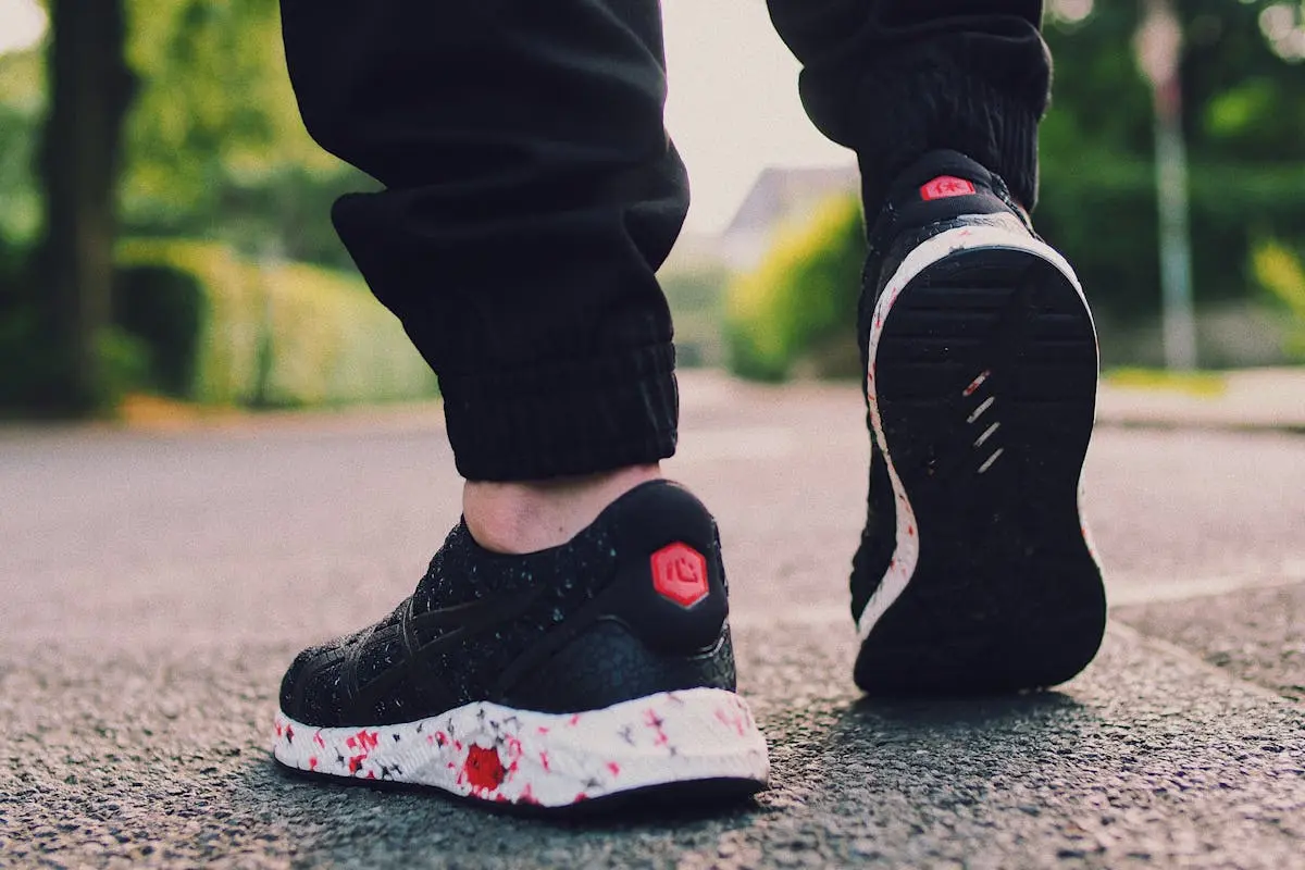 Person in Black Sneakers Walking on Street