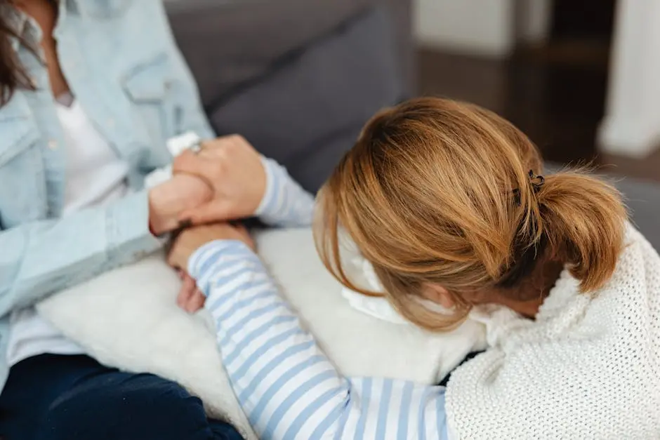 Two women share a comforting moment, emphasizing support and empathy in emotional distress.