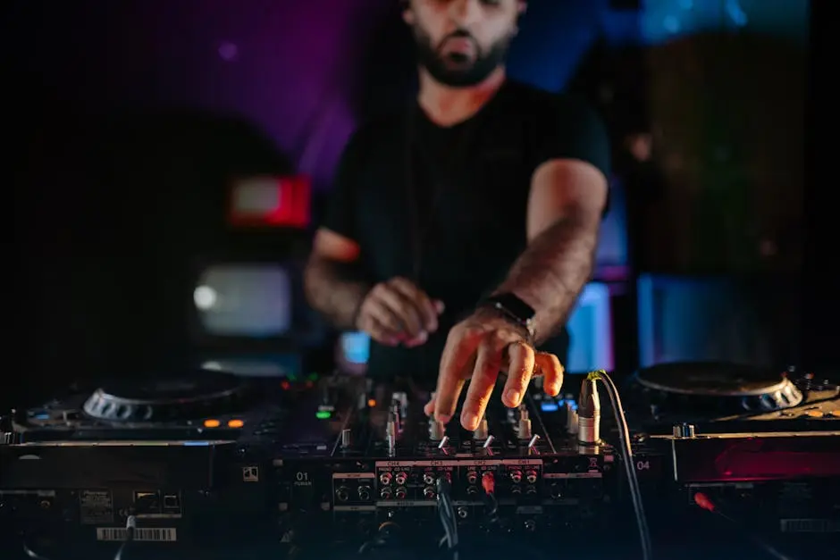 Energetic DJ spinning records at a lively nightclub with vibrant lighting and music.