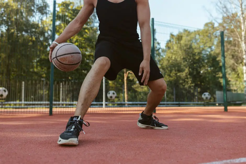 Athlete dribbling basketball on outdoor court. Perfect for sports and lifestyle imagery.