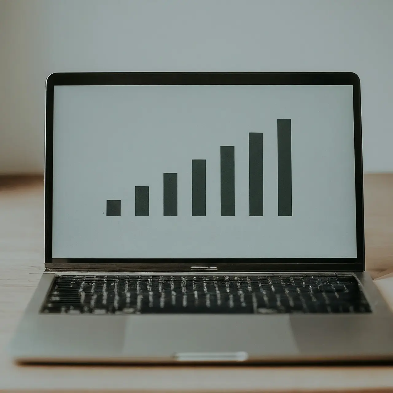 A sleek laptop with increasing graph icons on the screen. 35mm stock photo