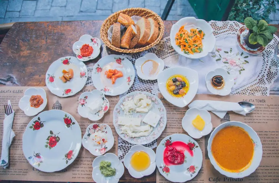 An inviting Turkish breakfast spread with diverse dishes on an outdoor wooden table.