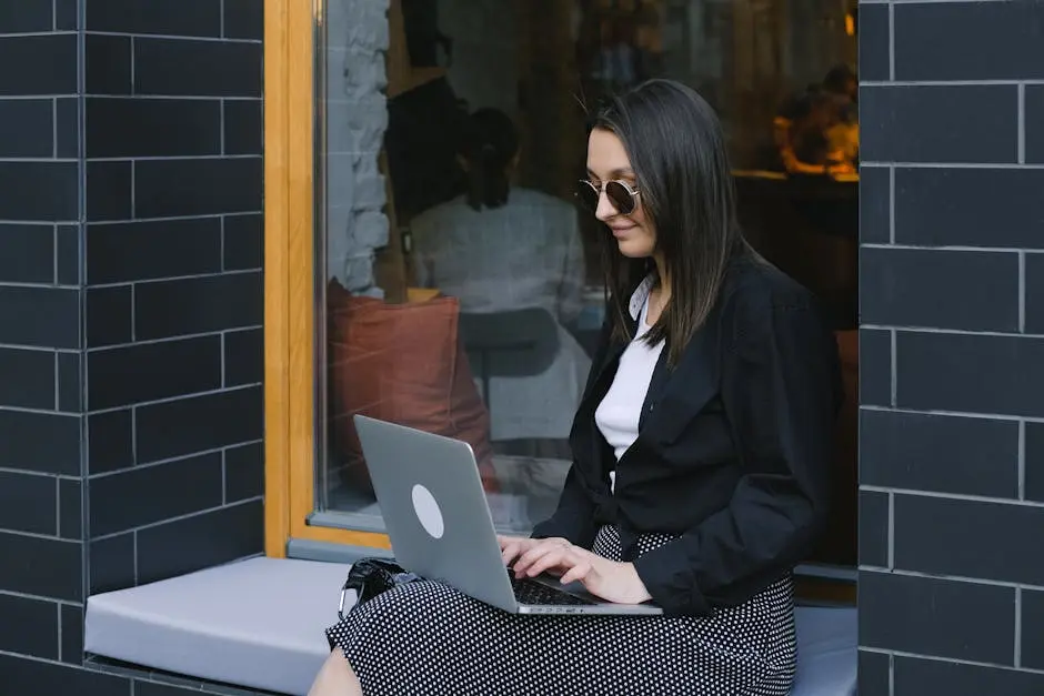 Woman in Black Blazer Using Macbook