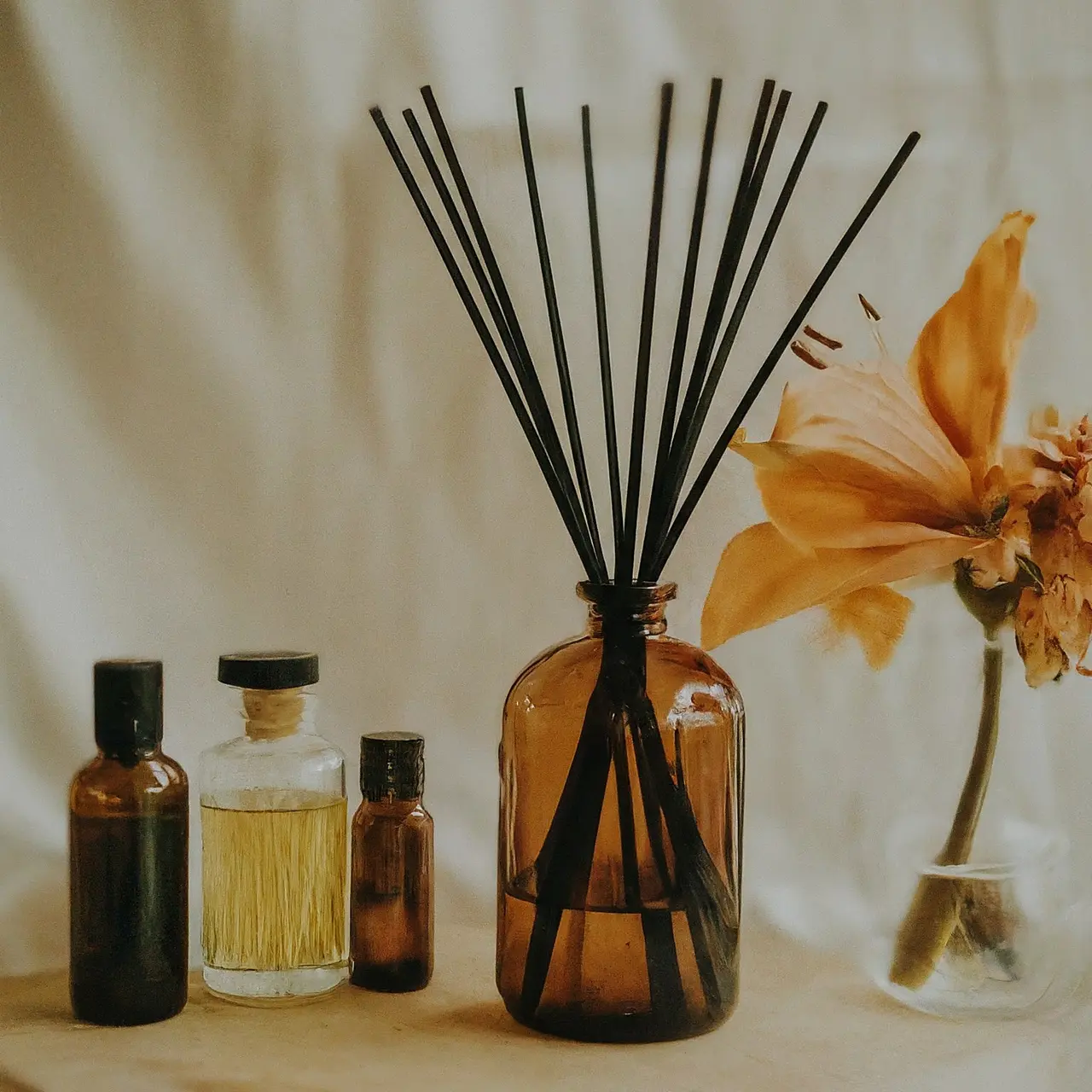 A variety of fragrance oil bottles with floral background. 35mm stock photo