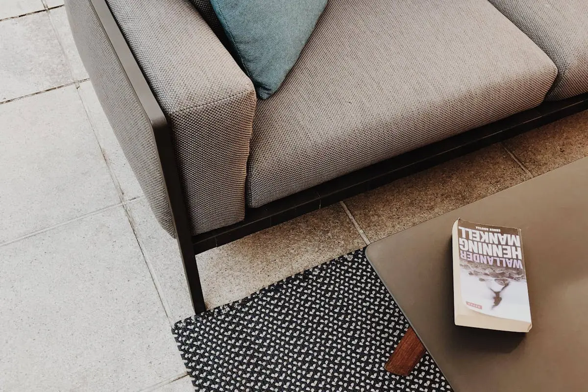 White and Brown Book on Table Near Couch