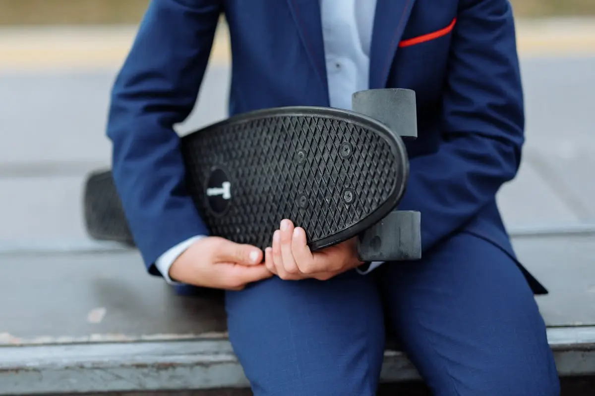 Person Holding a Black Penny Board