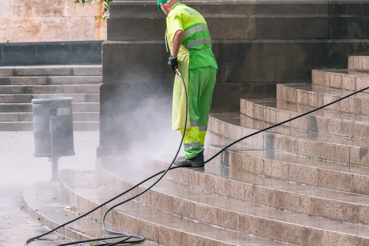 Man Cleaning Stairs on Street