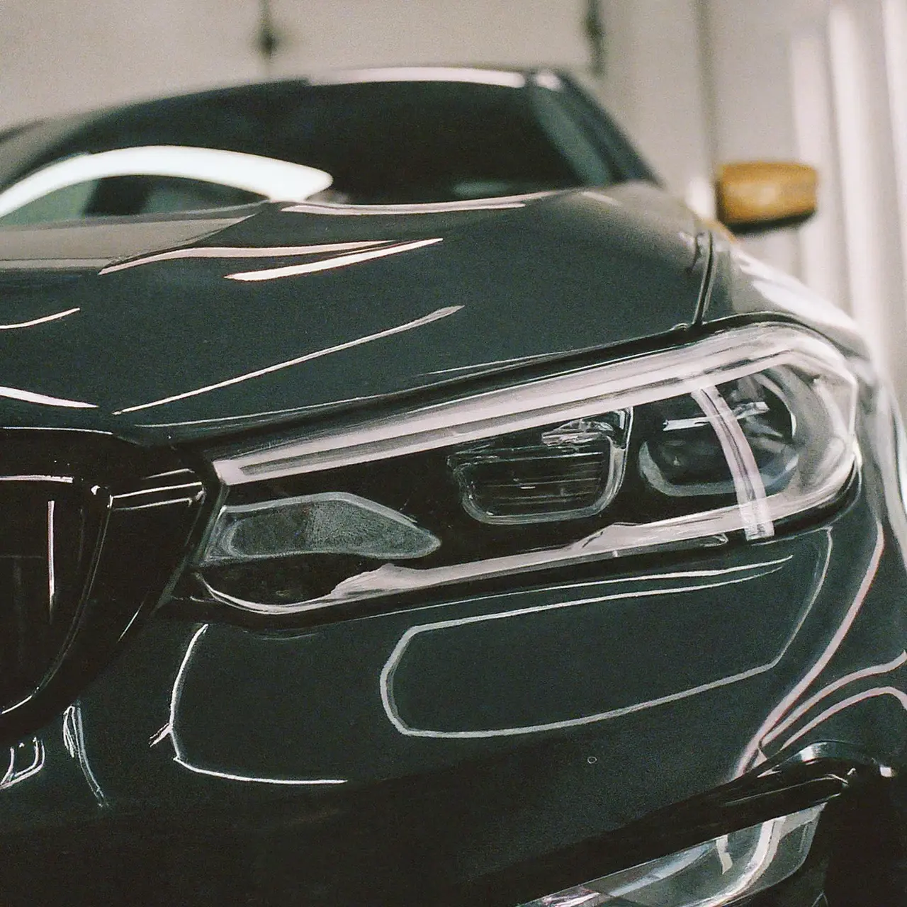 A sparkling car undergoing meticulous detailing. 35mm stock photo