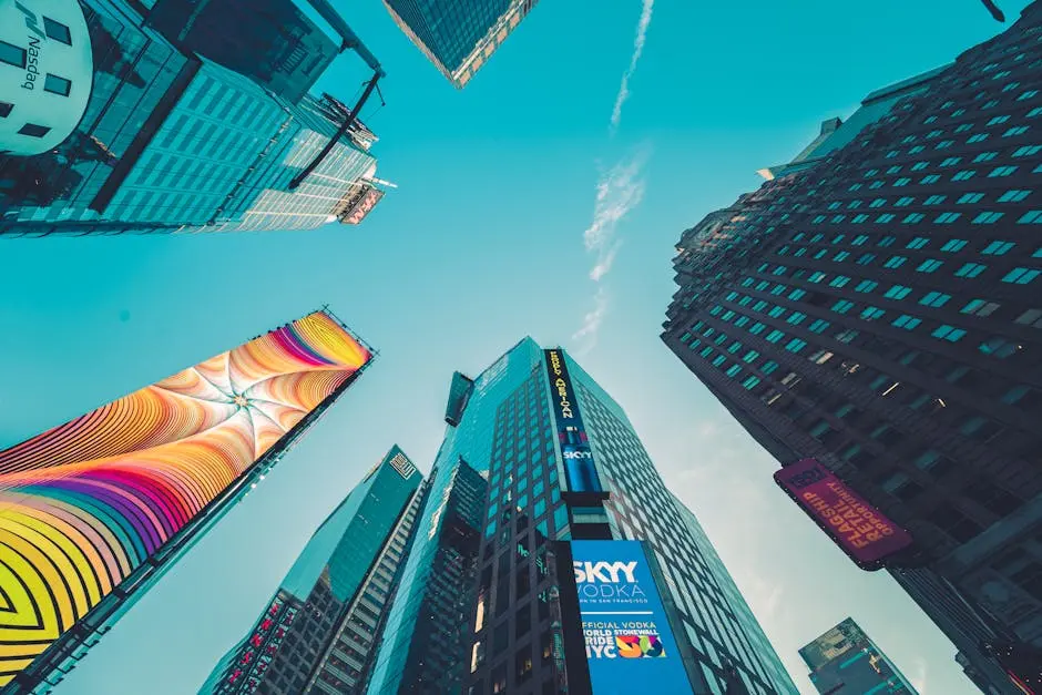 A low angle view of colorful skyscrapers in New York City with vivid signage.