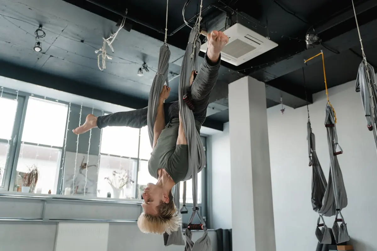 A Man Hanging on an Aerial Yoga Fabric