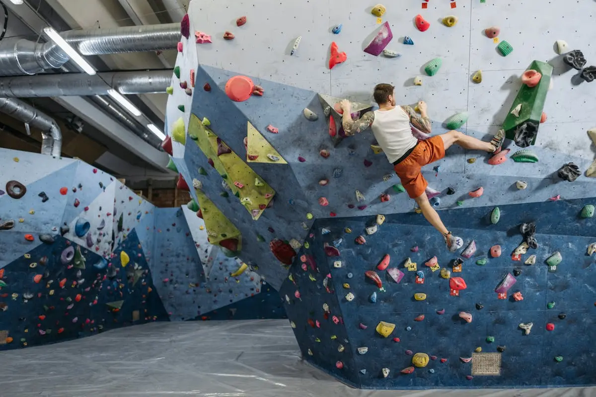 A Person in Activewear Climbing a Climbing Wall