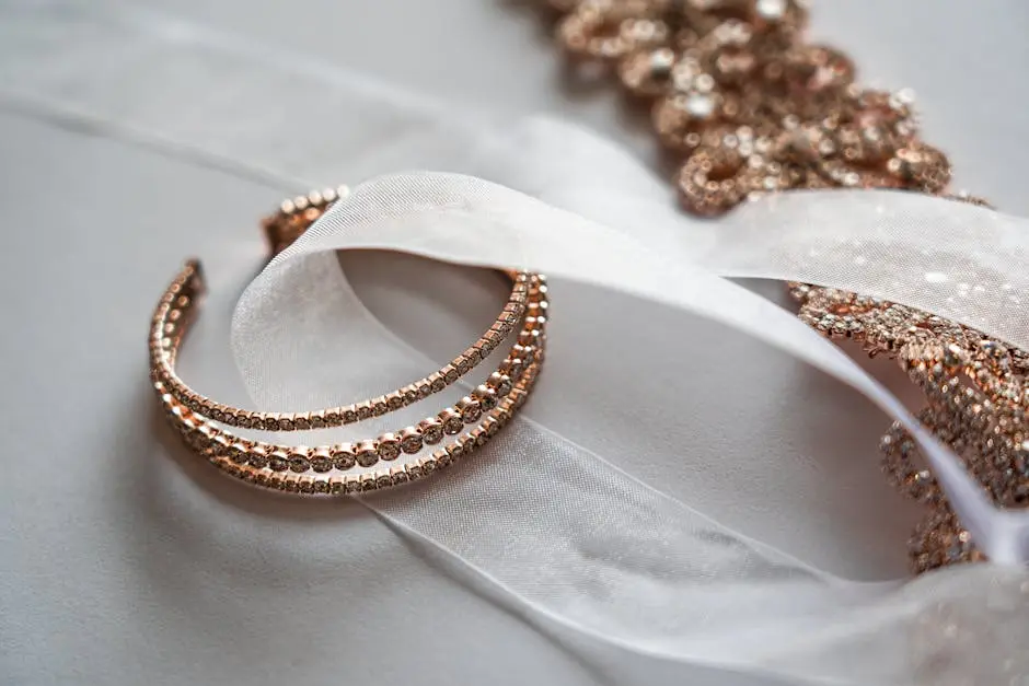 Close-up of luxurious rose gold jewelry on a sheer satin fabric, perfect for bridal occasions.