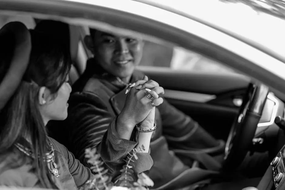 Newly married couple sitting in car