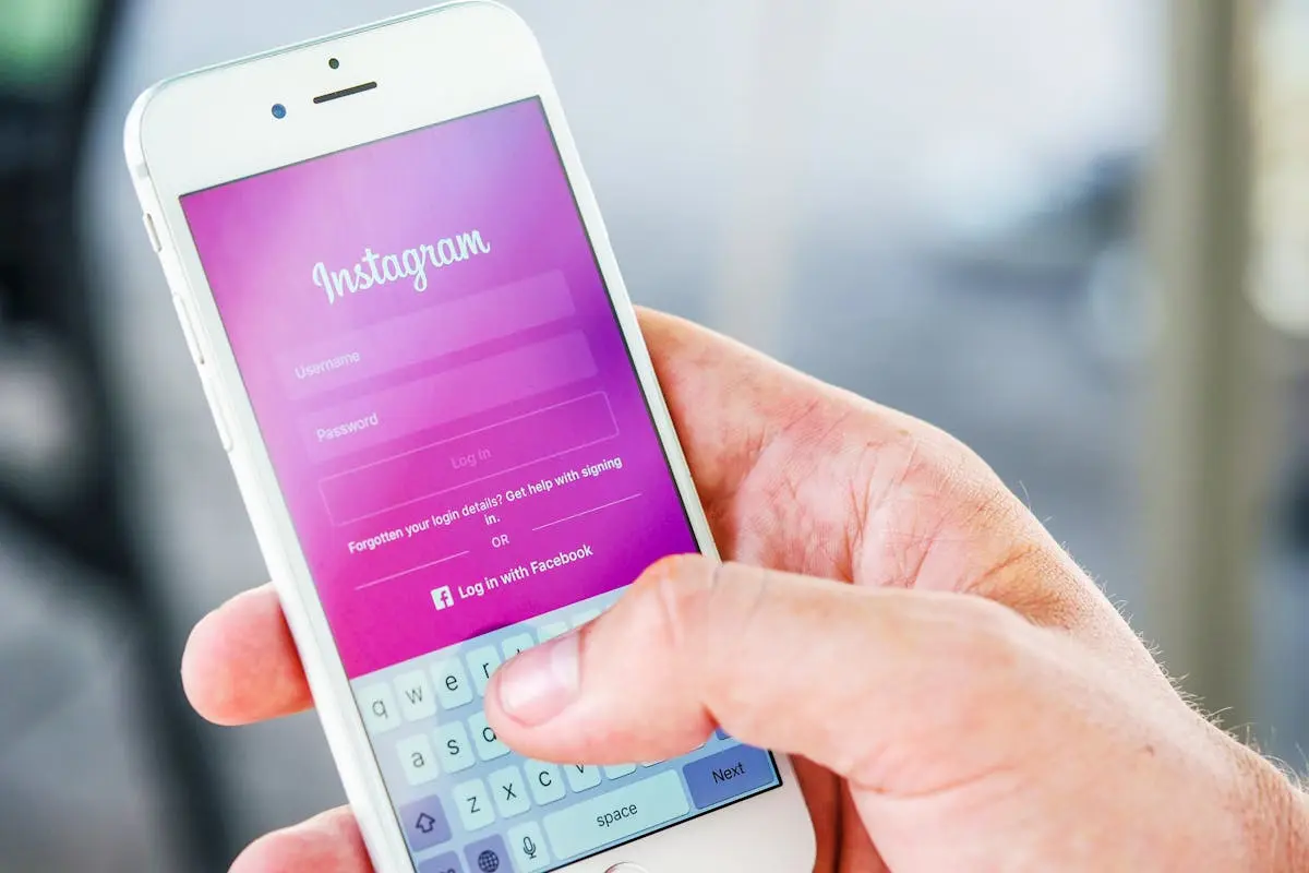 Close-up of a hand holding a smartphone displaying the Instagram login screen, highlighting mobile technology.