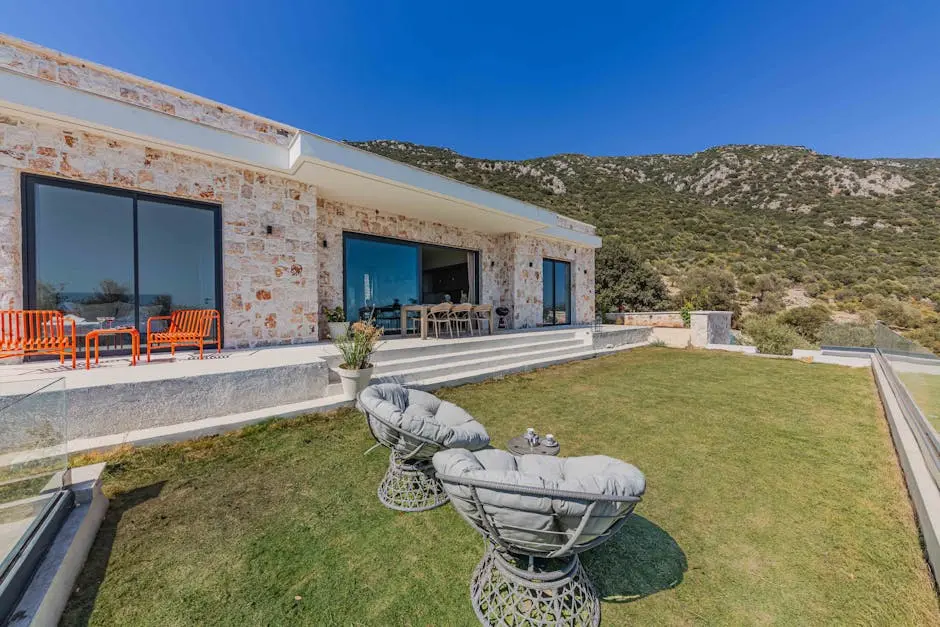 The villa is located on the hillside with a view of the sea