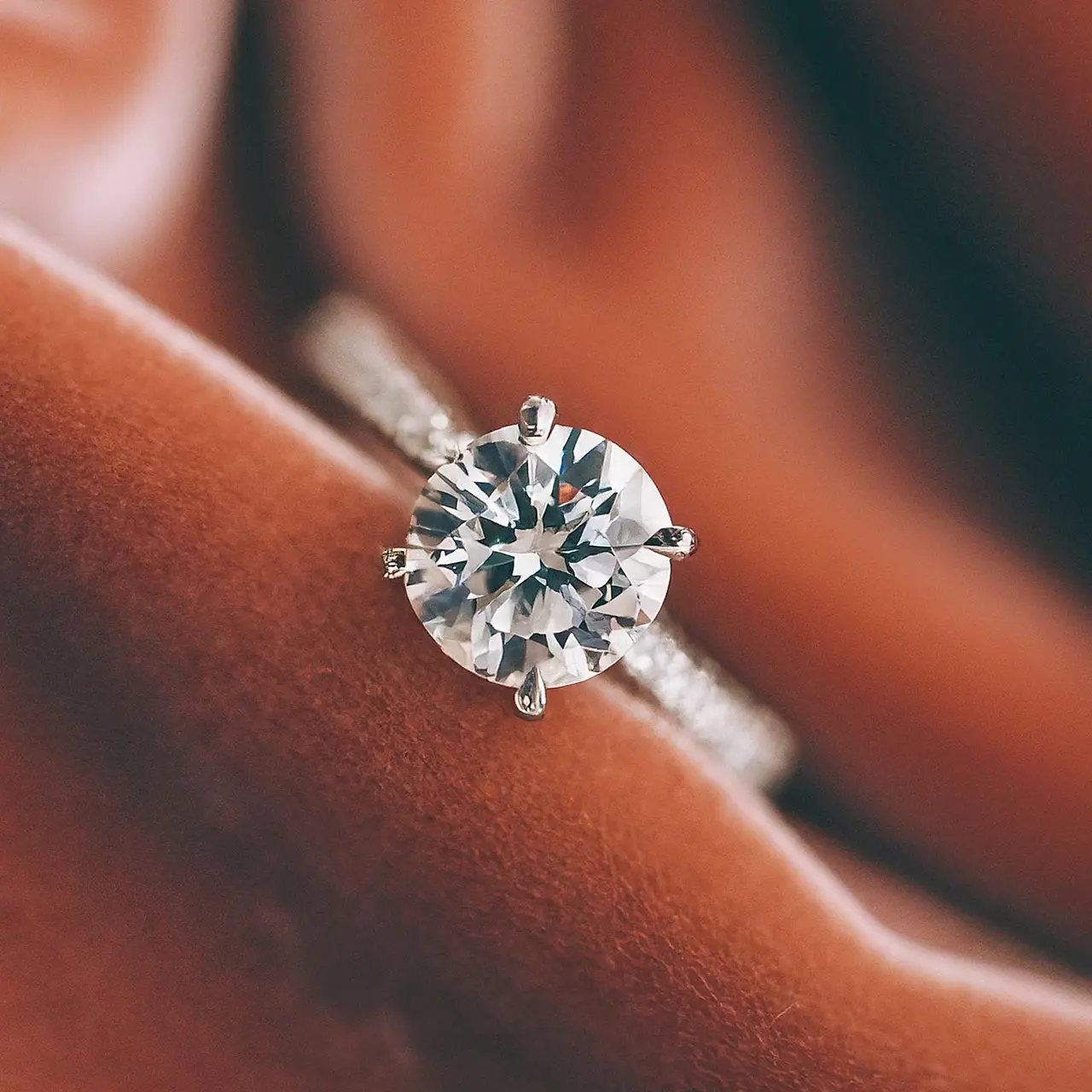 A sparkling lab-grown diamond ring against a soft, velvet background. 35mm stock photo