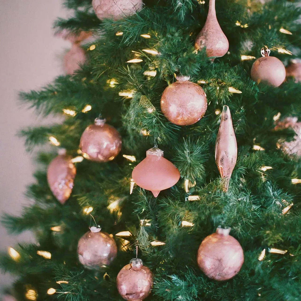 A Christmas tree adorned with pink decorations and lights. 35mm stock photo